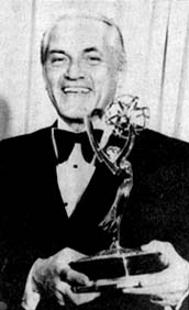 Newspaper photograph of Ted Knight in a tuxedo, smiling and holding an Emmy statuette.