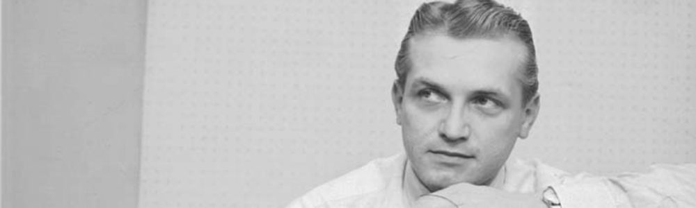 Ted Knight as a young man in the 1950s, in shirtsleeves, looking off to one side.